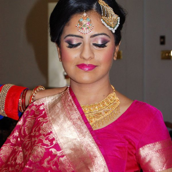 Bold makeup goes well with this sari at this bride's reception in Edgmont Contry Club in Edgemont, PA - bridal makeup and hair by Naz Beauty